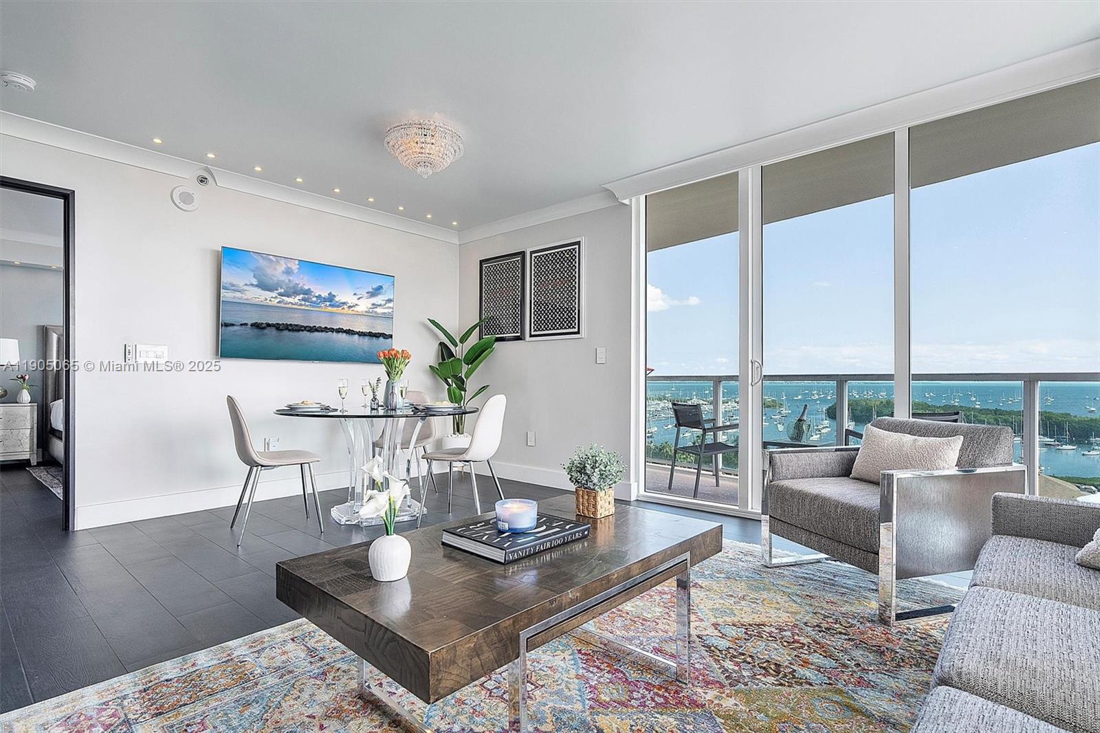 2889 McFarlane Road, Unit 902 Miami, FL 33133 - Photo 25 of 62 a living room with furniture wooden floor and a table