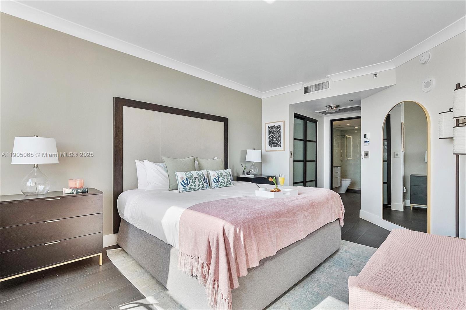 2889 McFarlane Road, Unit 902 Miami, FL 33133 - Photo 26 of 62 a bedroom with a bed and a lamp