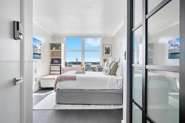 a living room with furniture and floor to ceiling windows