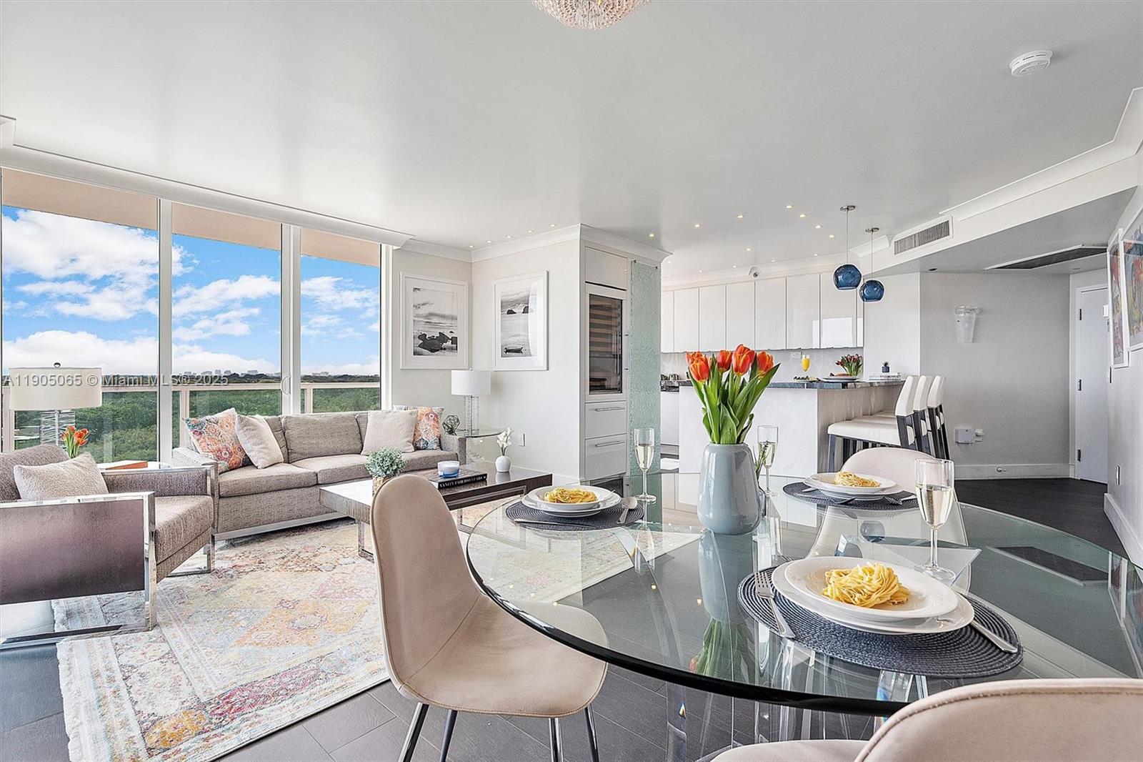 2889 McFarlane Road, Unit 902 Miami, FL 33133 - Photo 33 of 62 a living room with furniture and floor to ceiling windows