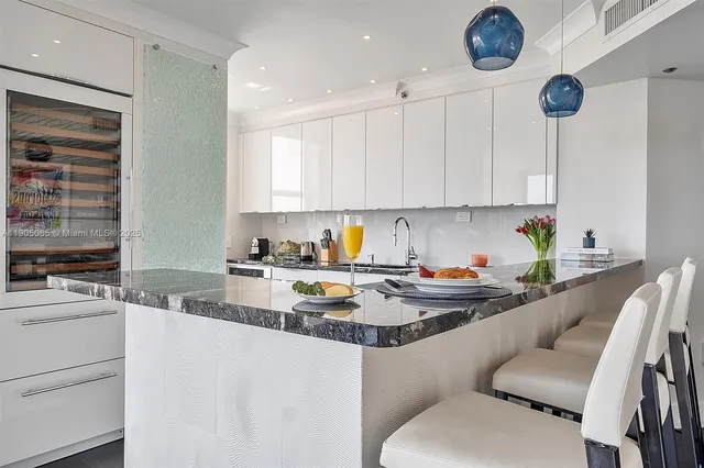 a living room with large windows and a table