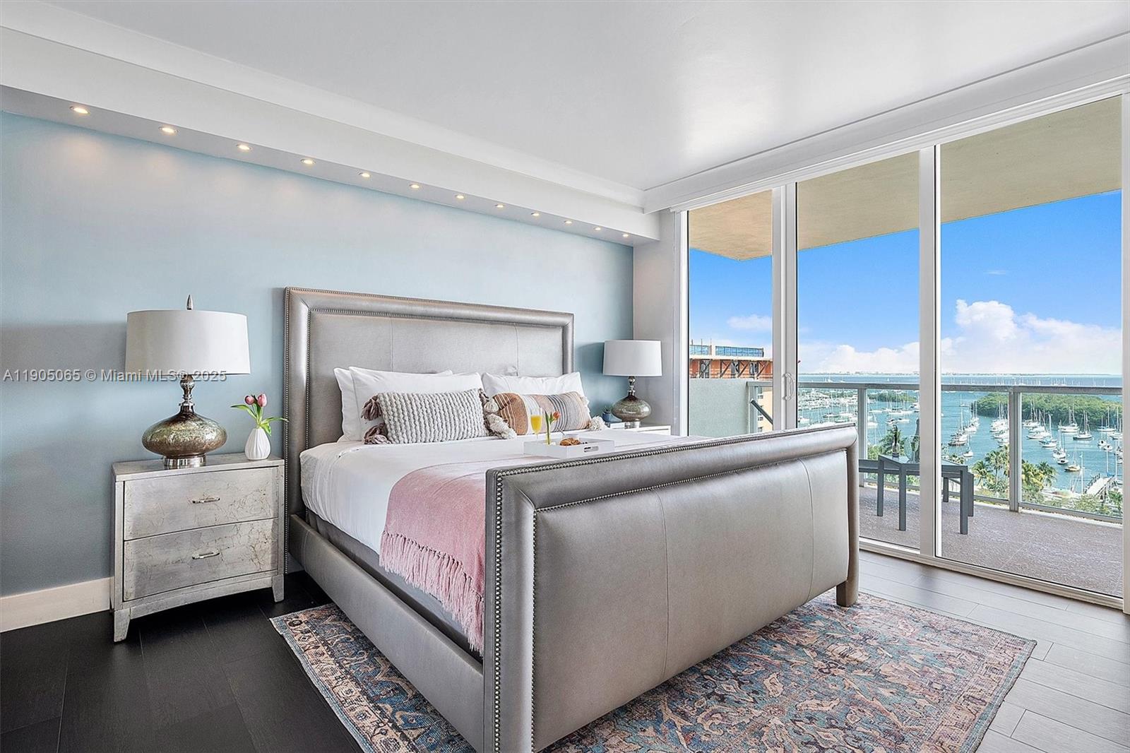 2889 McFarlane Road, Unit 902 Miami, FL 33133 - Photo 40 of 62 a bed room with a bed and a lamp