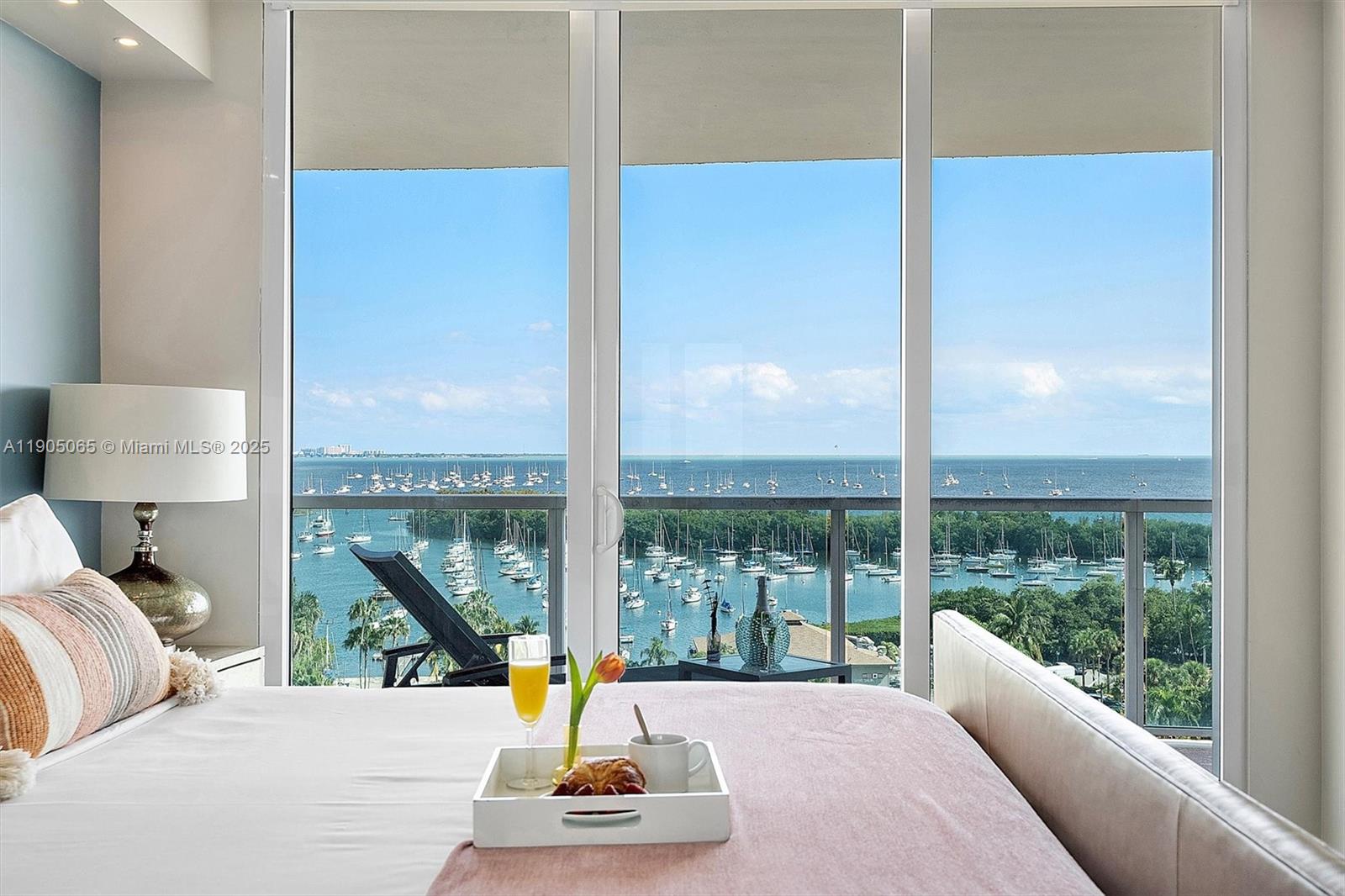 2889 McFarlane Road, Unit 902 Miami, FL 33133 - Photo 43 of 62 a living room with large windows and a table