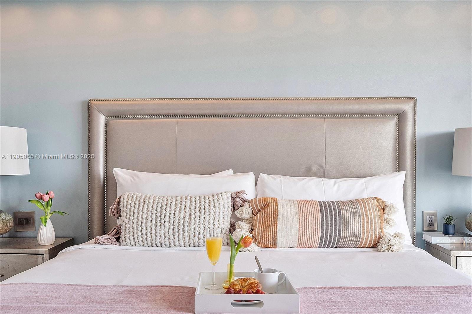 2889 McFarlane Road, Unit 902 Miami, FL 33133 - Photo 44 of 62 a bedroom with a bed and wooden floor