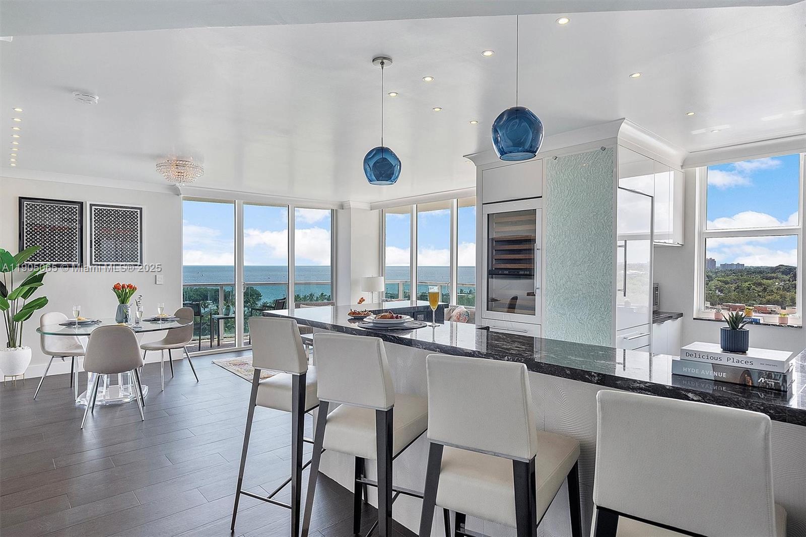 2889 McFarlane Road, Unit 902 Miami, FL 33133 - Photo 7 of 62 a dining room with wooden floor and large window