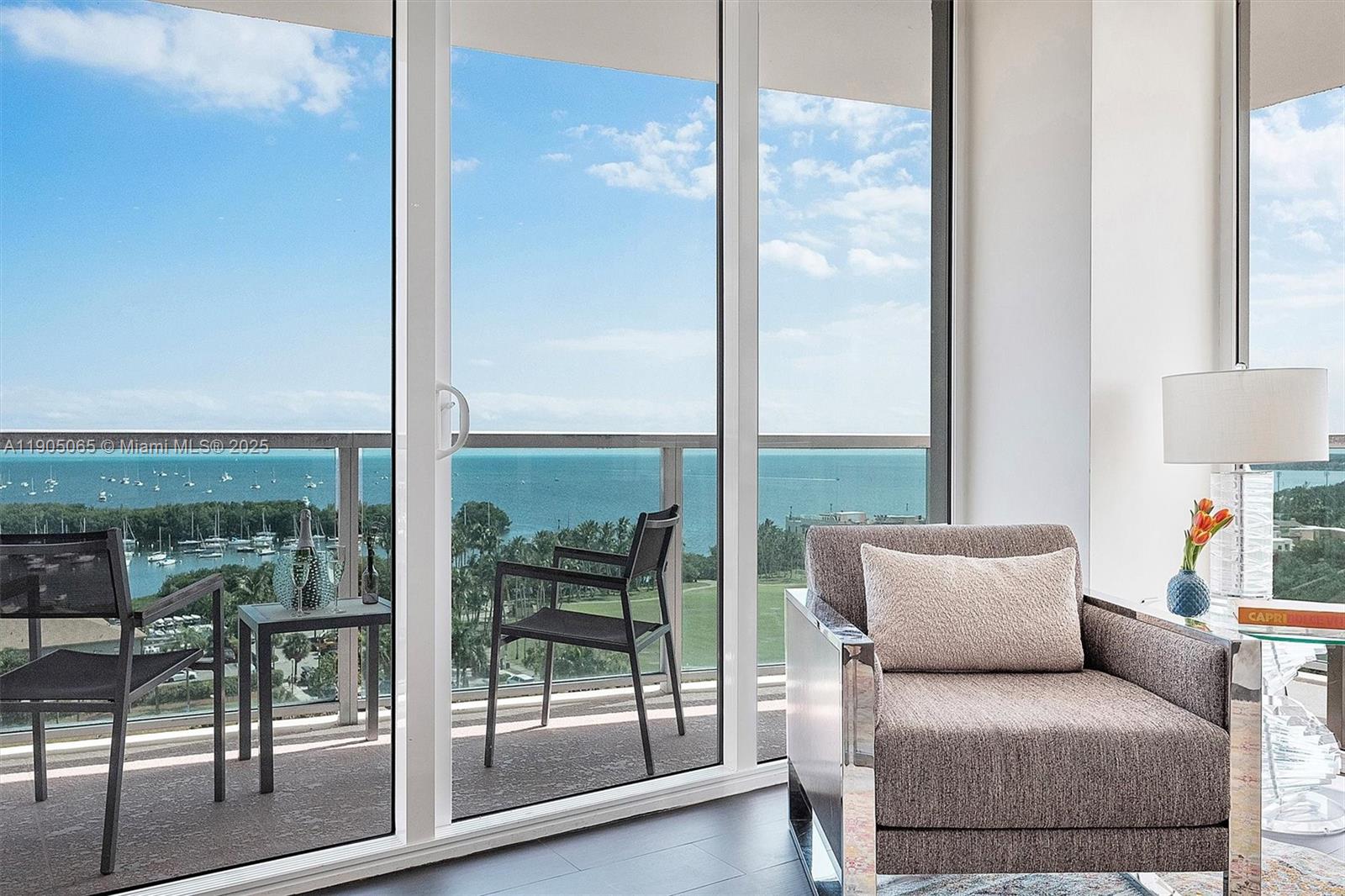 2889 McFarlane Road, Unit 902 Miami, FL 33133 - Photo 9 of 62 a living room with furniture and a floor to ceiling window