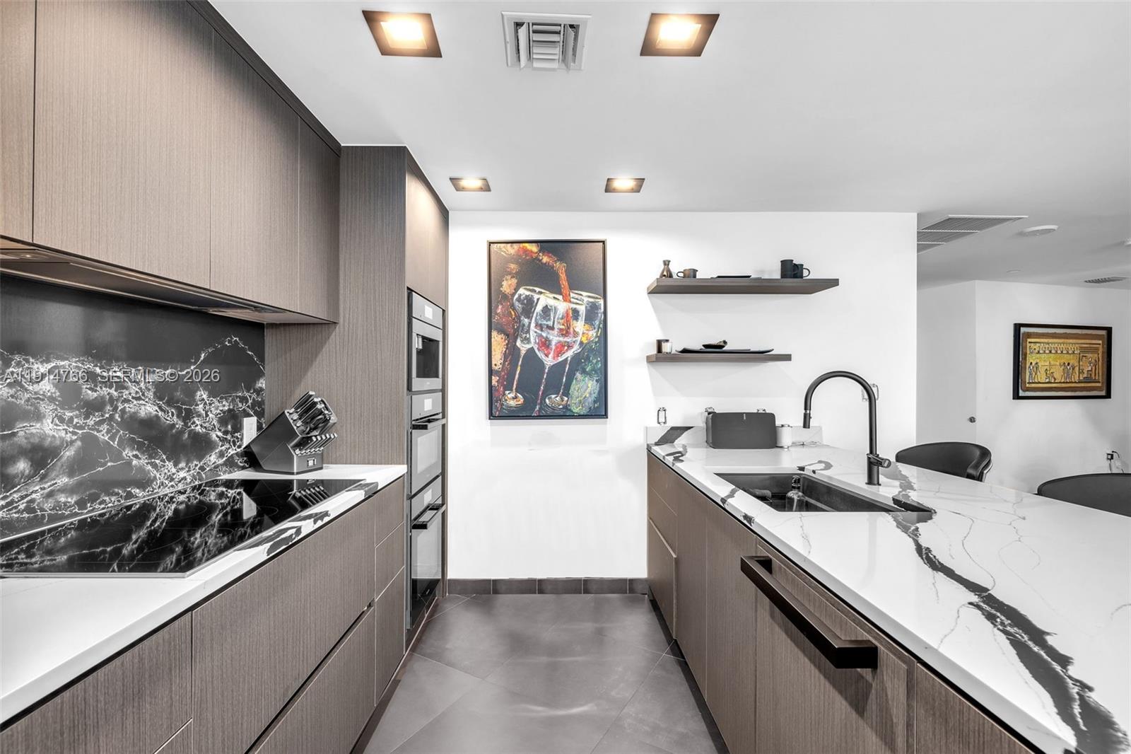 200 Biscayne Blvd Way, Unit 4408 Miami, FL 33131 - Photo 8 of 36 a kitchen with stainless steel appliances granite countertop a sink and a stove top oven