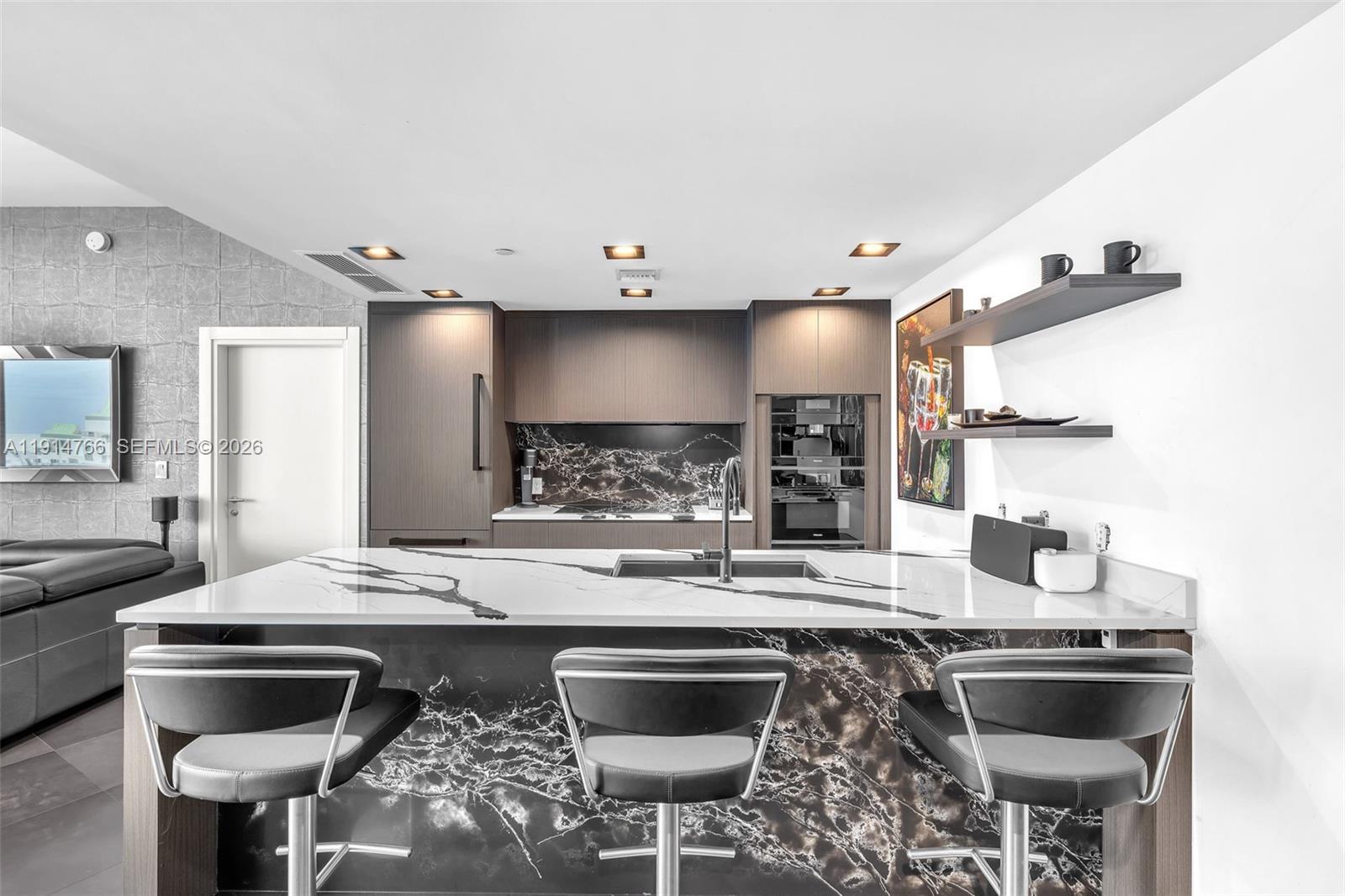 200 Biscayne Blvd Way, Unit 4408 Miami, FL 33131 - Photo 9 of 36 a kitchen with a stove a sink and a refrigerator