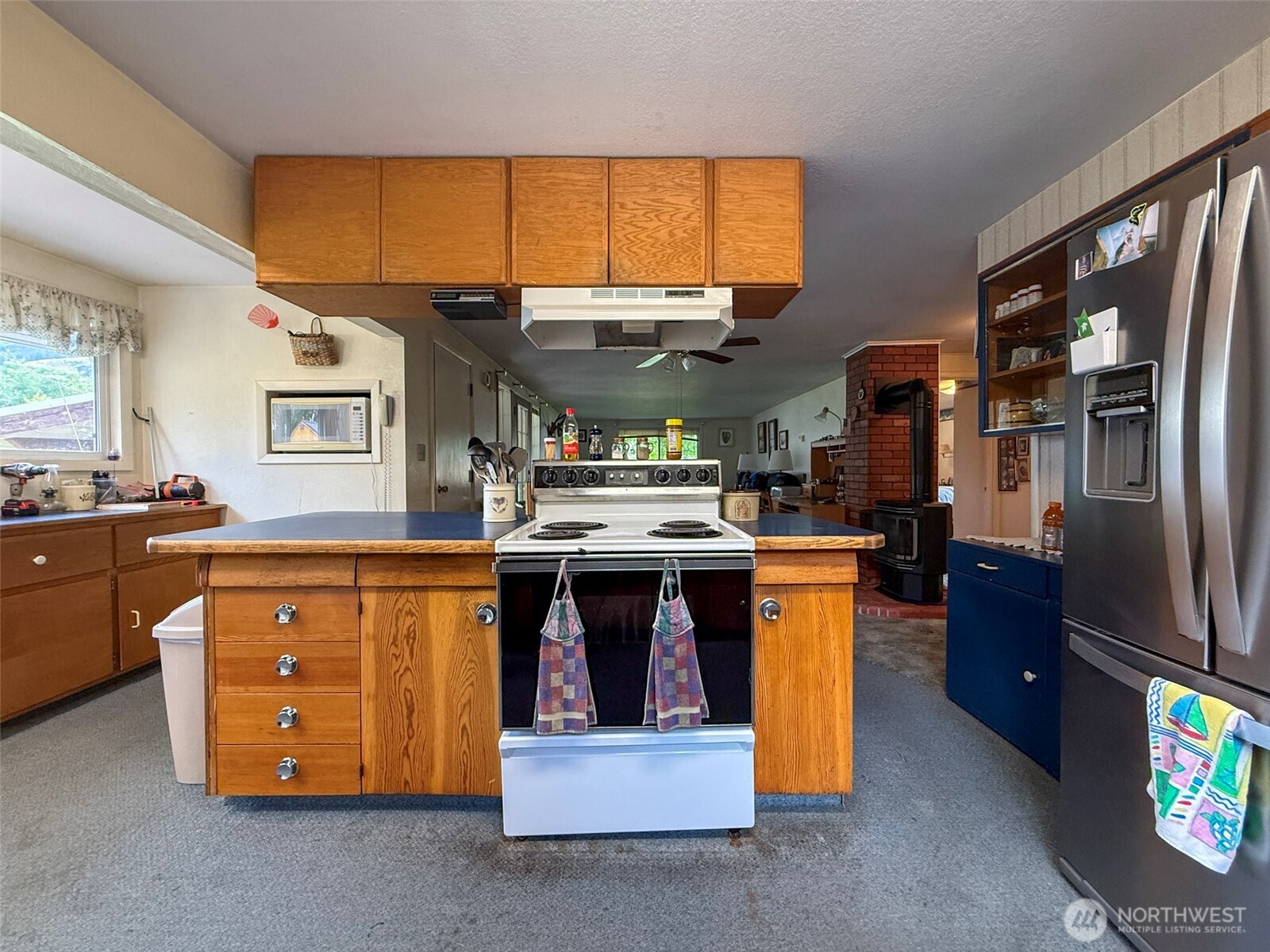 518 Bridge Street Twisp, WA 98856 - Photo 13 of 40 a kitchen with stainless steel appliances granite countertop a stove a sink and a refrigerator