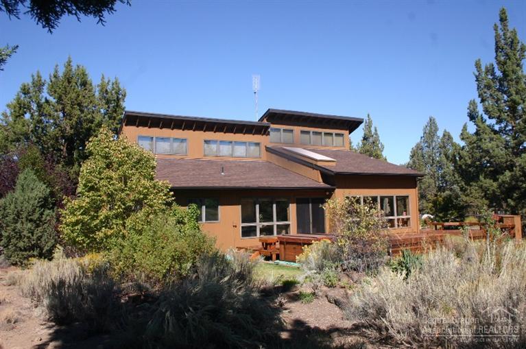 63488 Abbey Road Bend, OR 97701 - Photo 1 of 25 a front view of a house with a garden