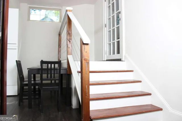 a view of entryway and hall with wooden floor