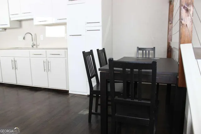 a view of a dining room with furniture and window