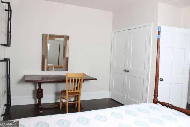 a bedroom with a bed and a table