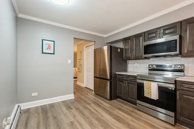 a kitchen with a refrigerator stove and microwave