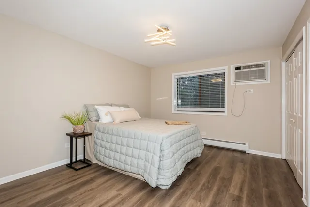 a bedroom with a bed and a window