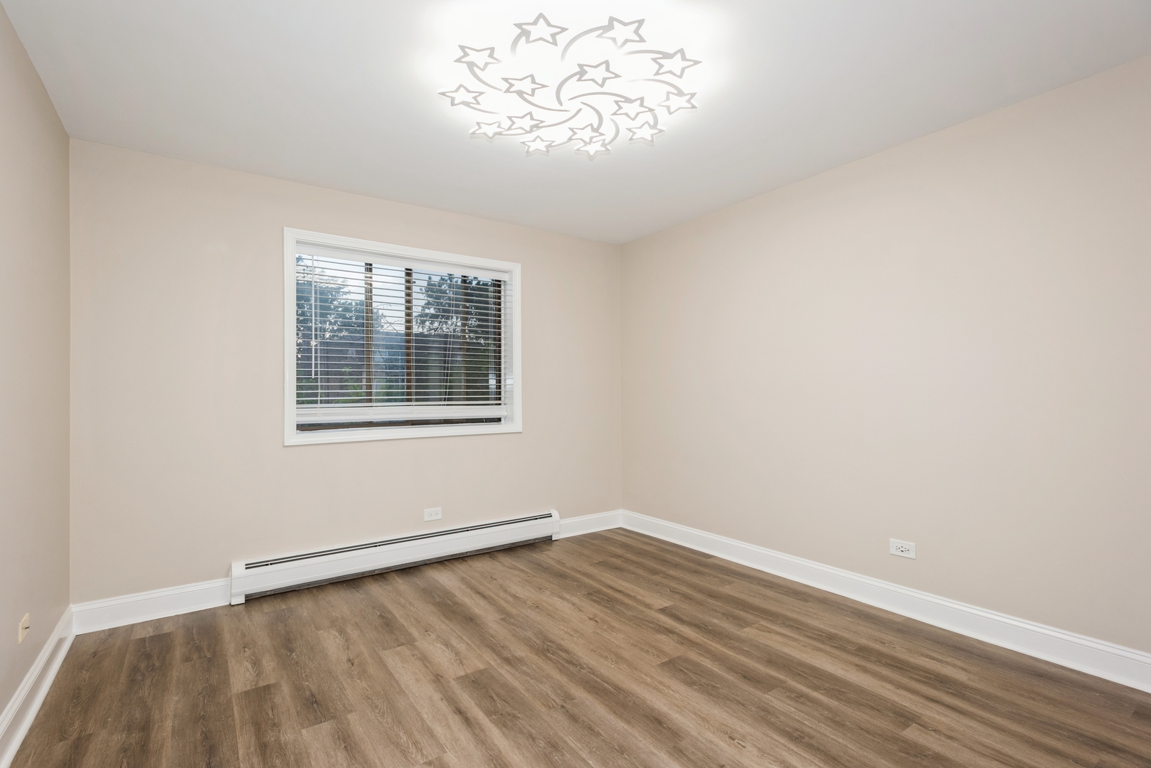 1212 Whispering Hills Court, Unit 2B Naperville, IL 60540 - Photo 9 of 10 wooden floor in an empty room with a window