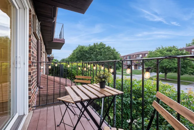 a view of balcony with wooden floor and outdoor seating