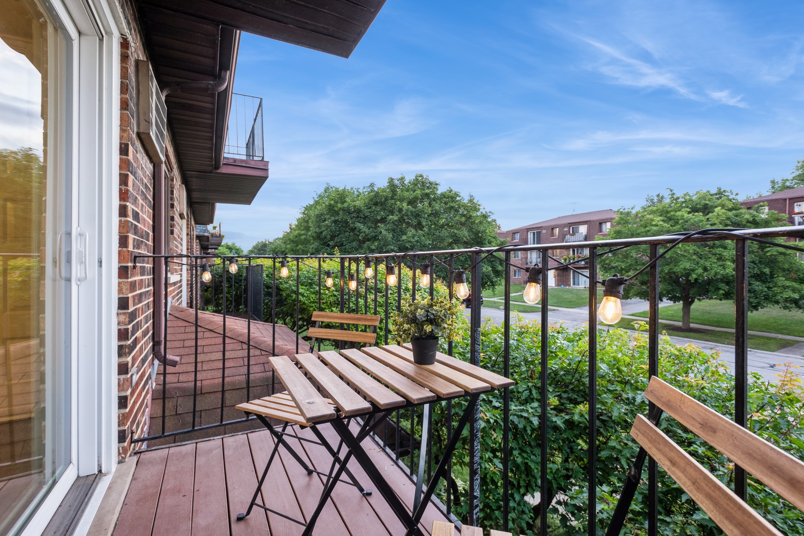 1212 Whispering Hills Court, Unit 2B Naperville, IL 60540 - Photo 10 of 10 a view of balcony with wooden floor and outdoor seating