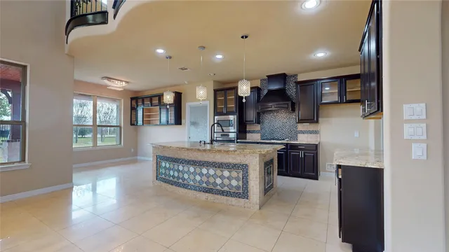 a large kitchen with stainless steel appliances granite countertop a stove and a sink