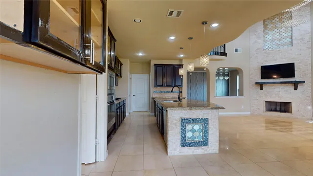a view of a living room with a fireplace and a floor to ceiling window