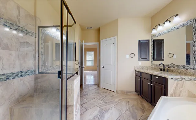 a bathroom with a sink and mirror with toilet