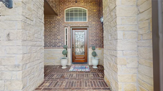 a view of a brick house with a large window
