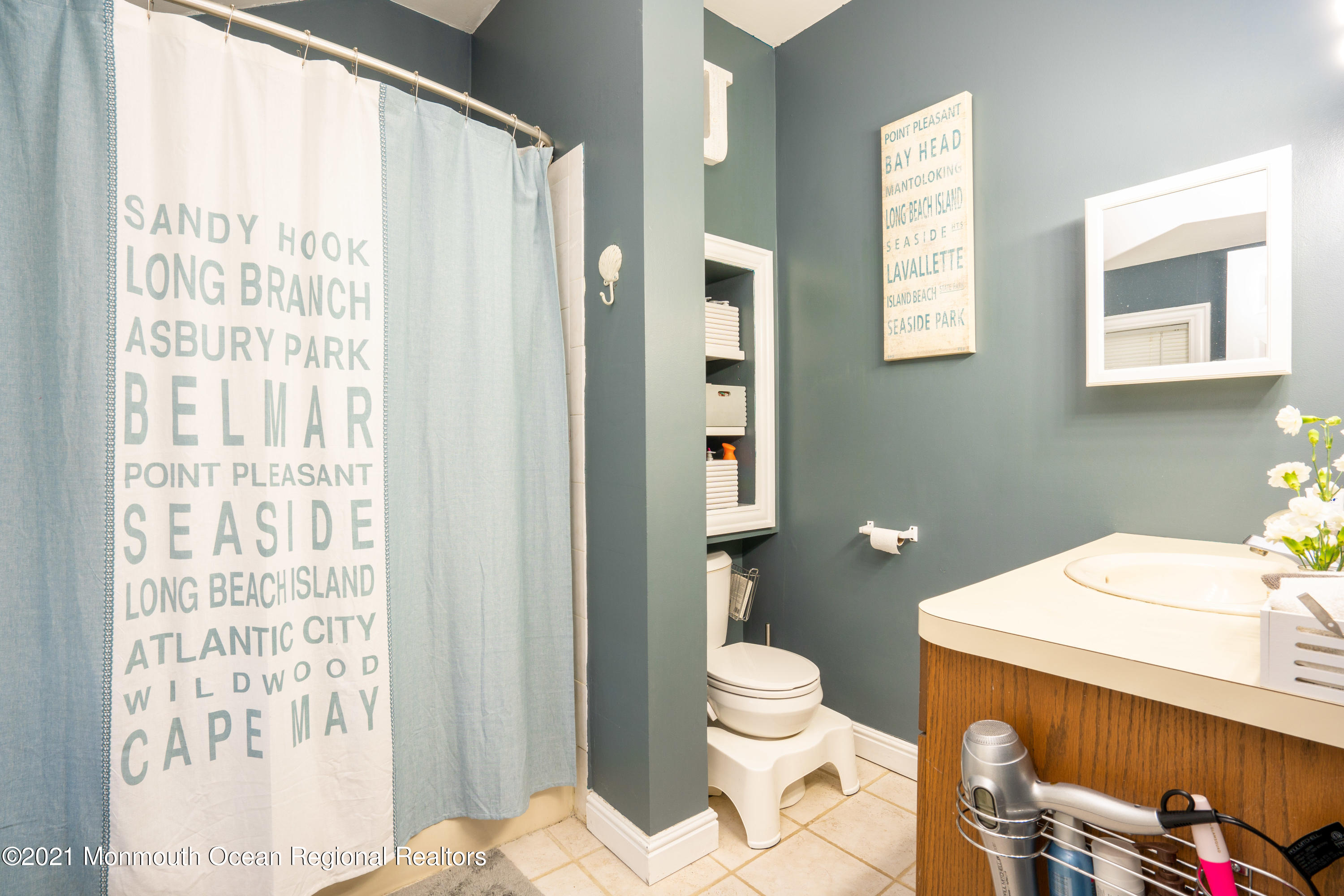 198 Adelphia Road Farmingdale, NJ 07727 - Photo 26 of 28 a bathroom with a sink a toilet and shower curtain