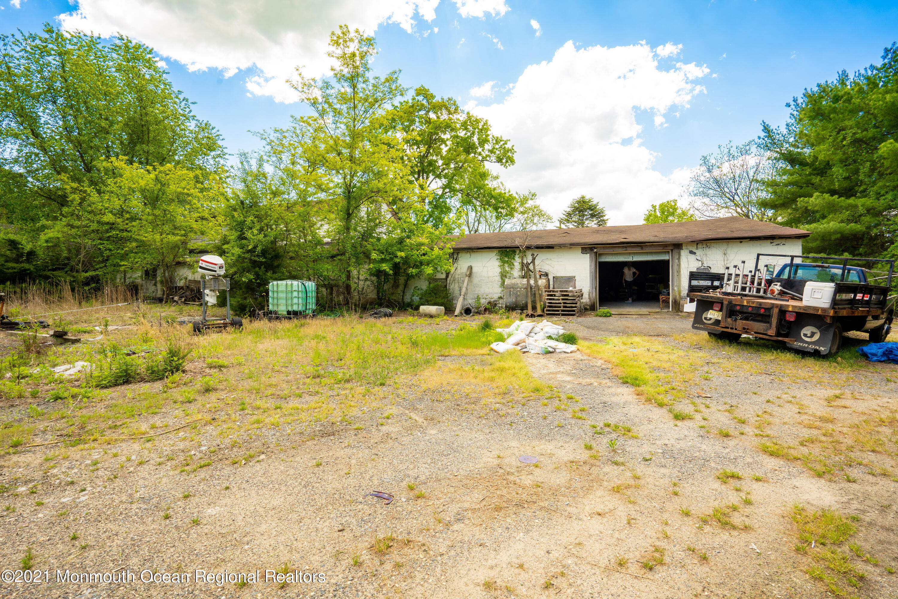 198 Adelphia Road Farmingdale, NJ 07727 - Photo 28 of 28 a view of swimming pool with outdoor seating and house in the background