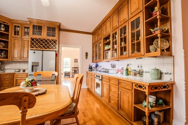 a spacious bedroom with a bed and wooden floor