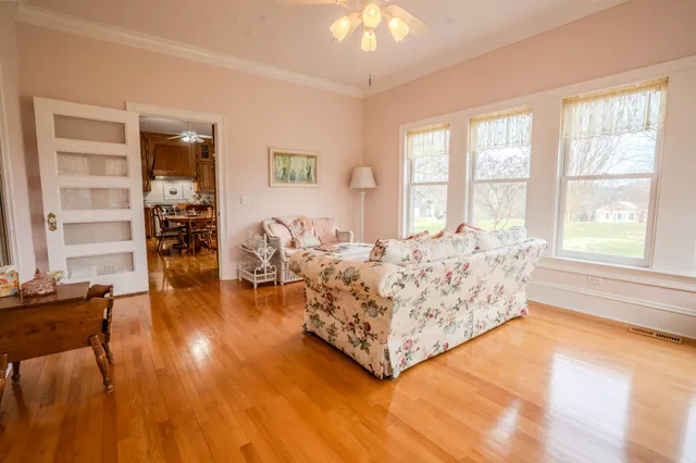 a kitchen with stainless steel appliances a stove a window and wooden floor