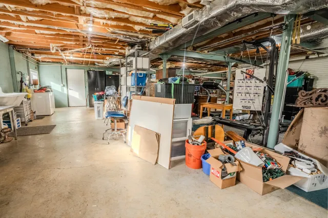 an aerial view of residential houses with outdoor space and trees