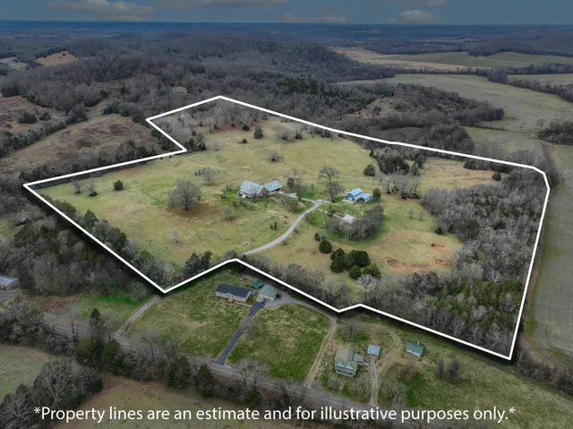a front view of house with yard and car parked