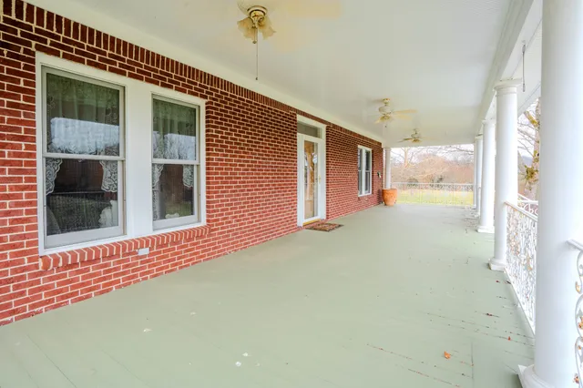 a view of a porch with a table and chairs