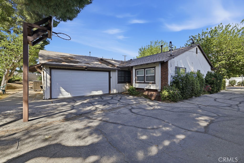 25102 Wheeler Road Newhall, CA 91321 - Photo 2 of 9 a front view of a house with a garden