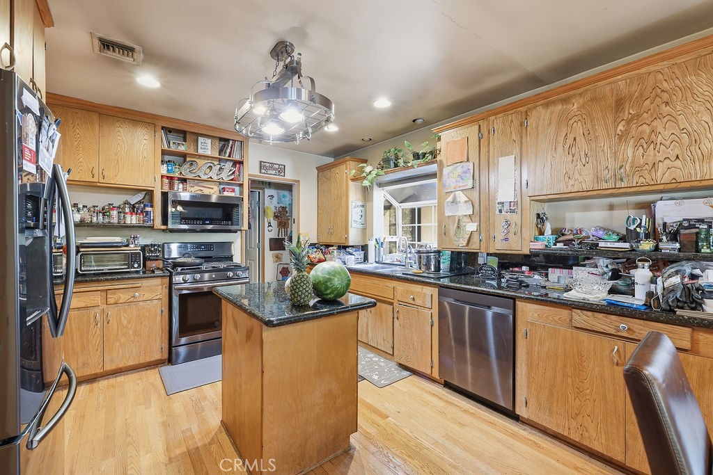 25102 Wheeler Road Newhall, CA 91321 - Photo 3 of 9 a kitchen with stainless steel appliances granite countertop a sink stove and refrigerator