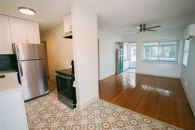 a view of a refrigerator in kitchen and living room