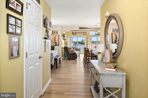 a living room with furniture a chandelier and a floor to ceiling window