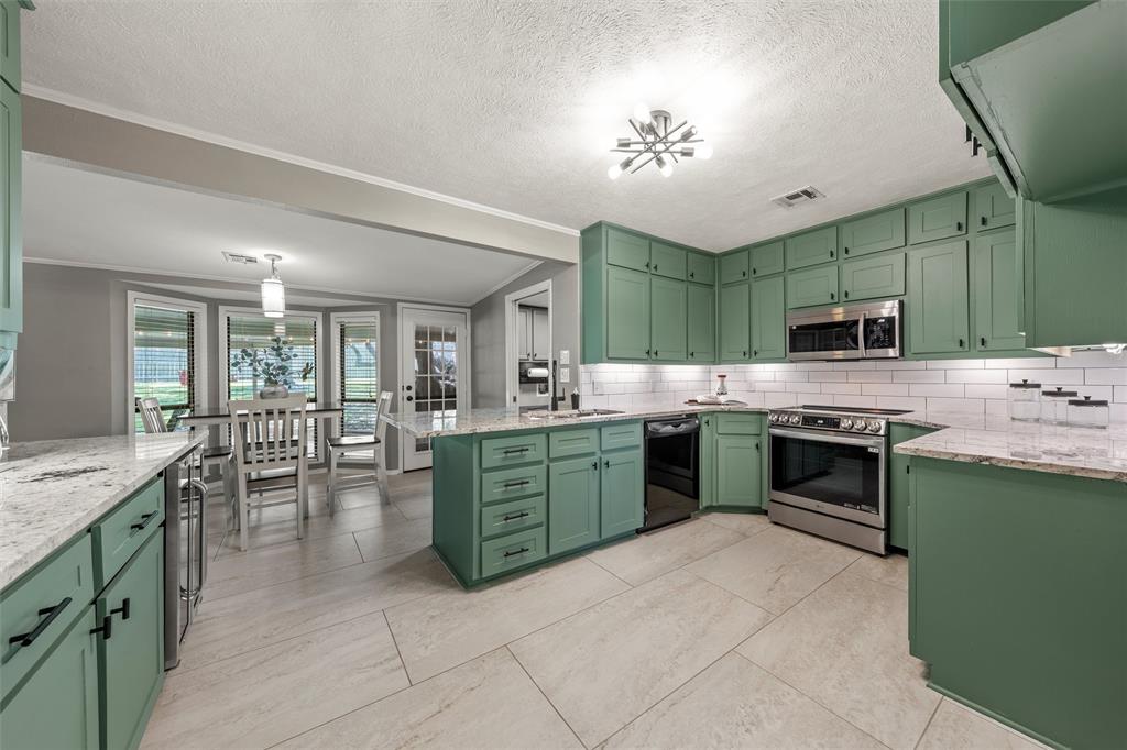 3924 North 30th Street Waco, TX 76708 - Photo 11 of 33 Light, bright kitchen with cabinets galore, great updated appliances, and view of guests and outdoors.