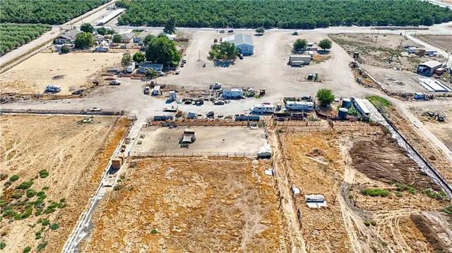 an aerial view of a house with a yard and lake view