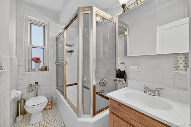 a bathroom with a sink toilet a mirror and shower