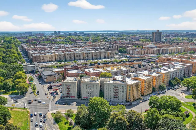 a view of a city with tall buildings and a big yard