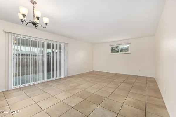 a living room with furniture a window and a chandelier