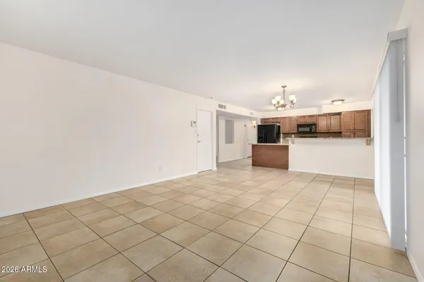 a living room with furniture a chandelier and a table