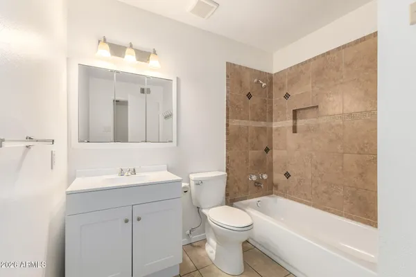 an empty room with wooden floor closet and fan chandelier fan