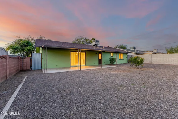 a view of a house with a yard and a garage