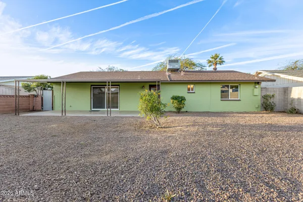a view of a house with a backyard