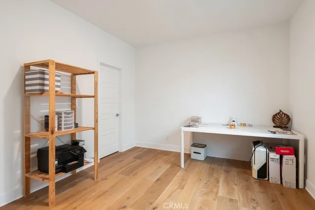 a view of a workspace with furniture and wooden floor