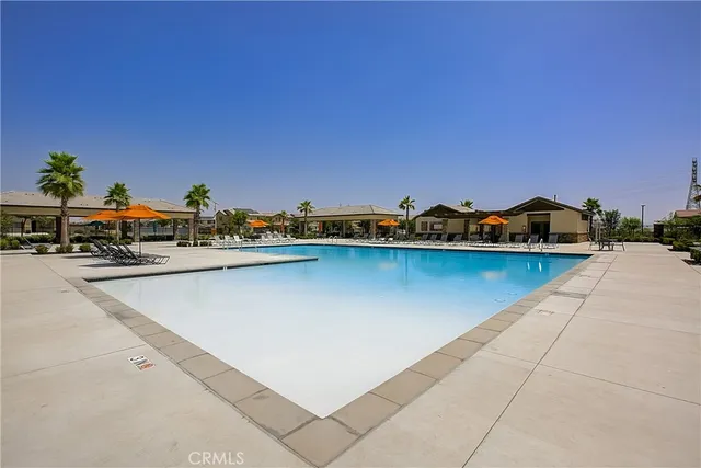 a swimming pool with outdoor seating and yard