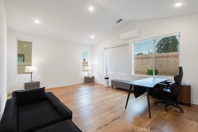 a view of a workspace with furniture and a window