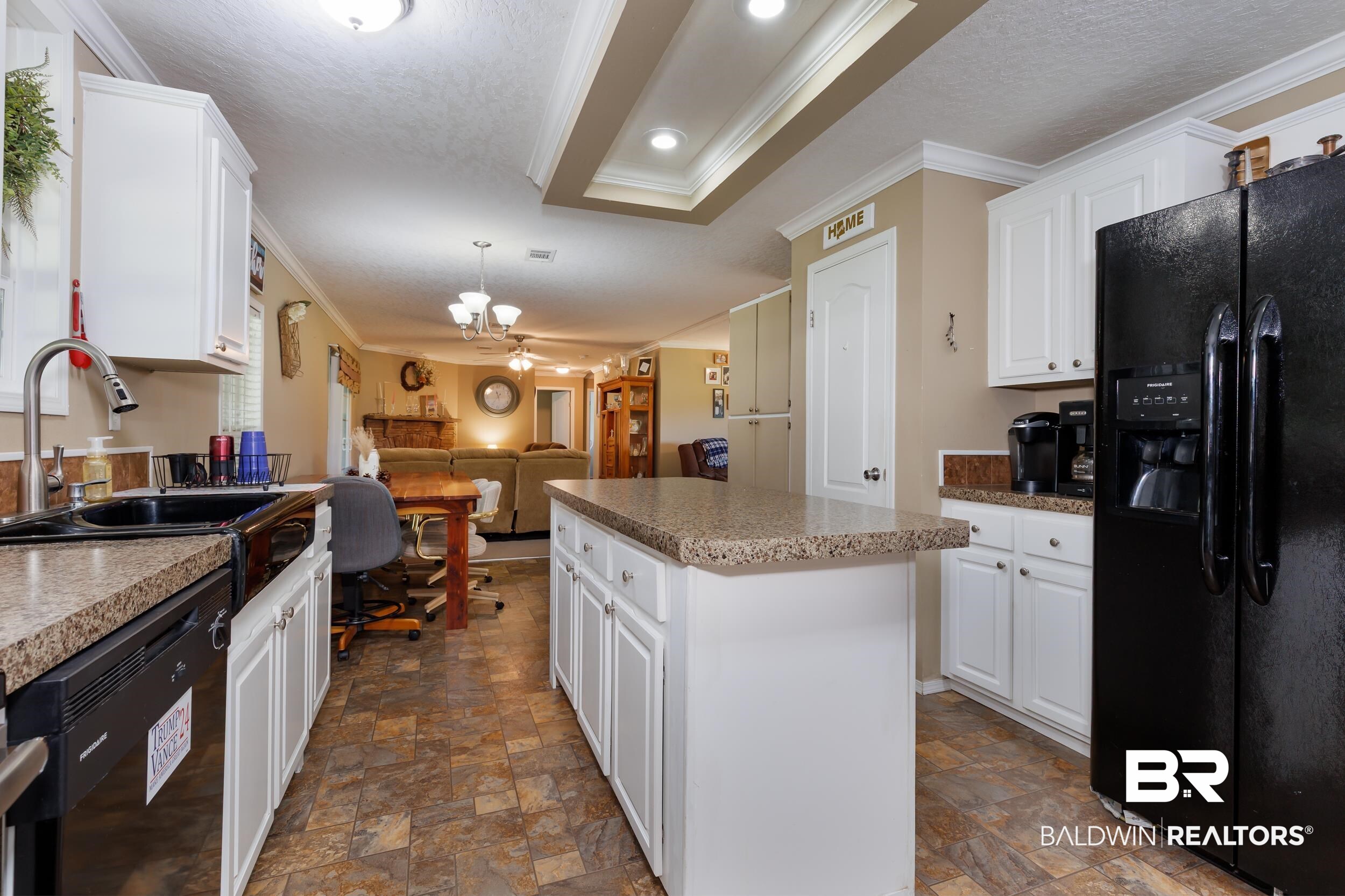 6725 Upper Creek Road Flomaton, AL 36441 - Photo 41 of 61 Kitchen featuring black appliances, a sink, stone finish floors, ornamental molding, and a chandelier
